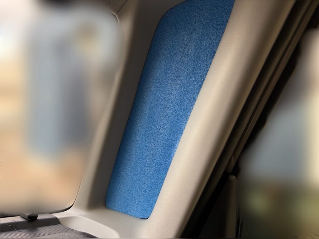 スペーシアベースの運転席側の細長い小窓に、自作した青色の目隠しマットをはめ込んだ様子